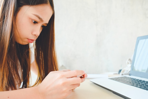 Woman used smart phone - young business using smartphone in coffee shop, copy space background