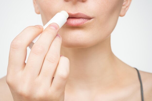 woman uses hygienic moisturizing lip balm