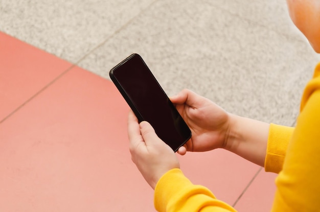 Woman uses a smartphone closeup Female hands typing a message on a mobile phone