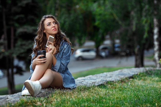 Woman uses smartphone outdoors