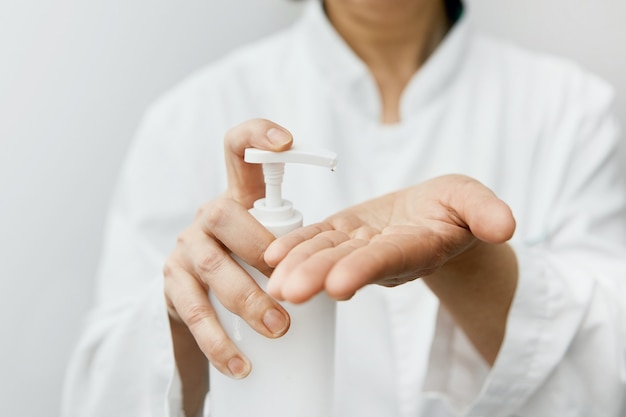 Woman using alcohol gel to clean hands