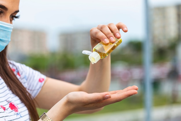 Woman using antibacterial hand sanitizer.