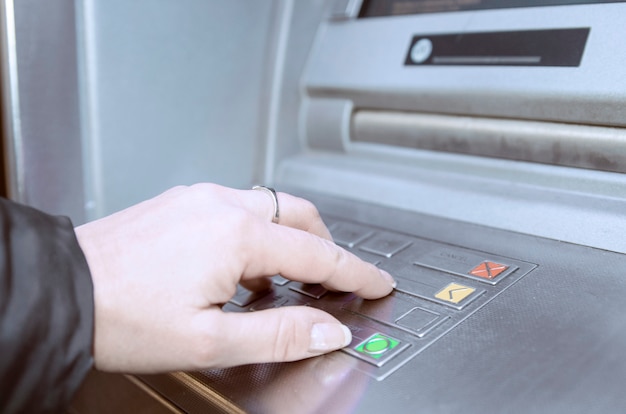 Woman using ATM bank machine