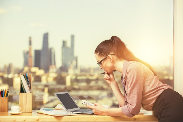 Woman using blank laptop