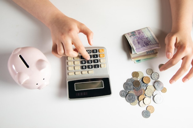 Woman using calculator and money