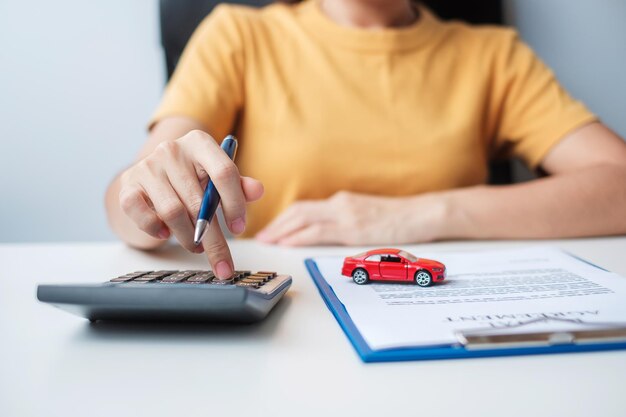 Woman using calculator during signing contract document buy and sale insurance rental and contract agreement concepts