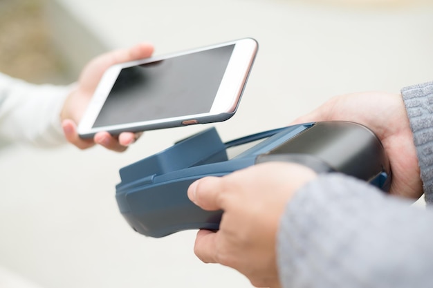 Woman using cellphone for payment