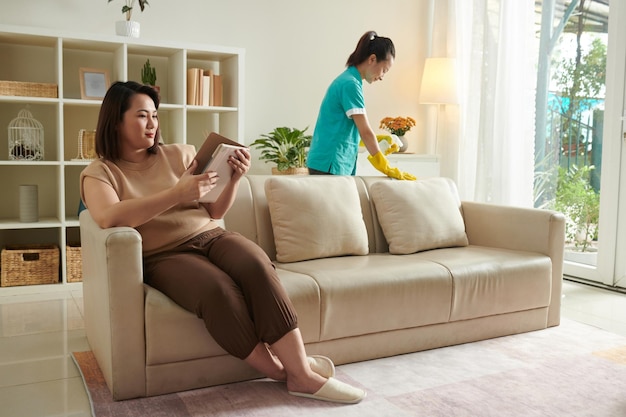 Woman using cleaning service to clean apartment