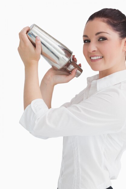 Woman using cocktail shaker