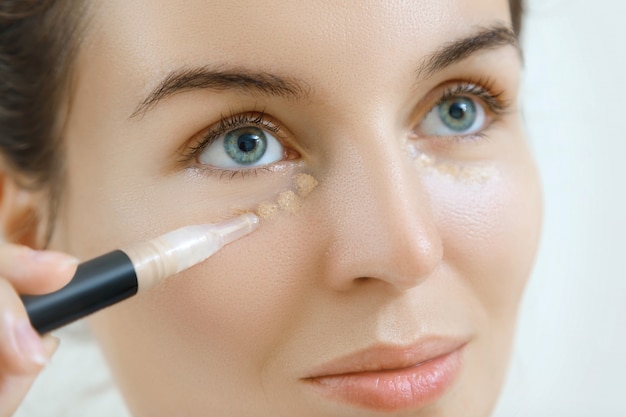 Woman using concealer