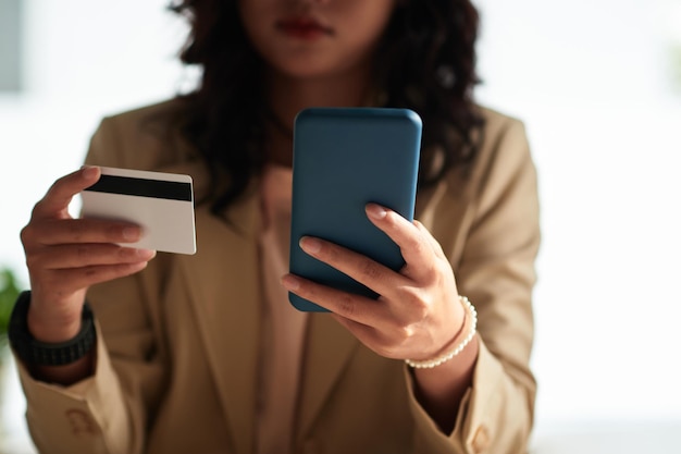 Woman using credit card to pay online