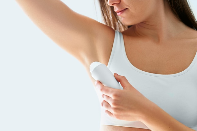 Woman using deodorant stick for sweating protection