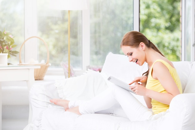 Woman using digital tablet at home.