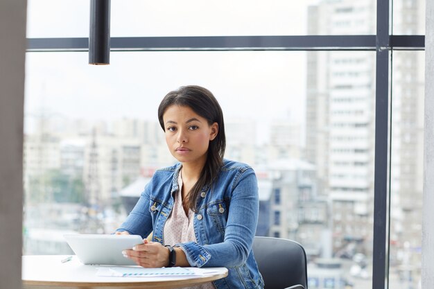 Woman using digital tablet at office