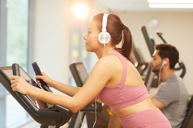 Woman Using Exercise Bike in Gym