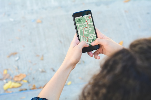 Woman using GPS map navigation app with planned route