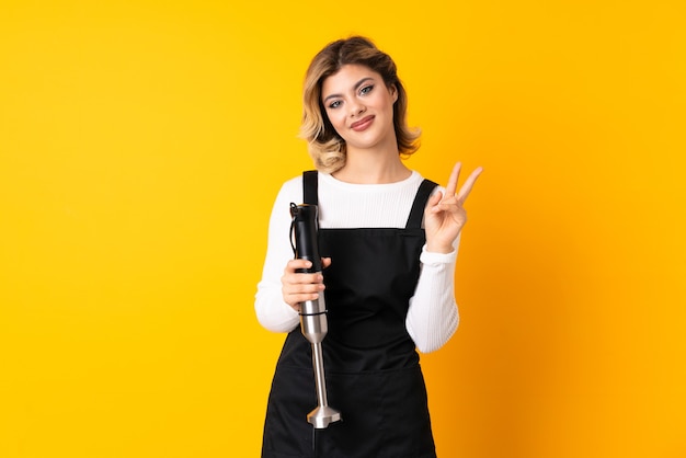 Woman using hand blender