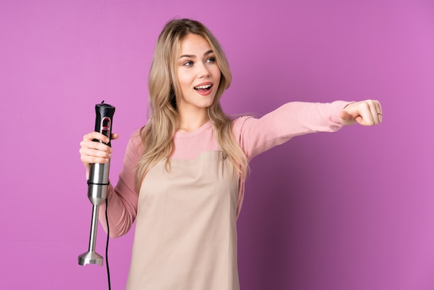 Woman using a hand blender