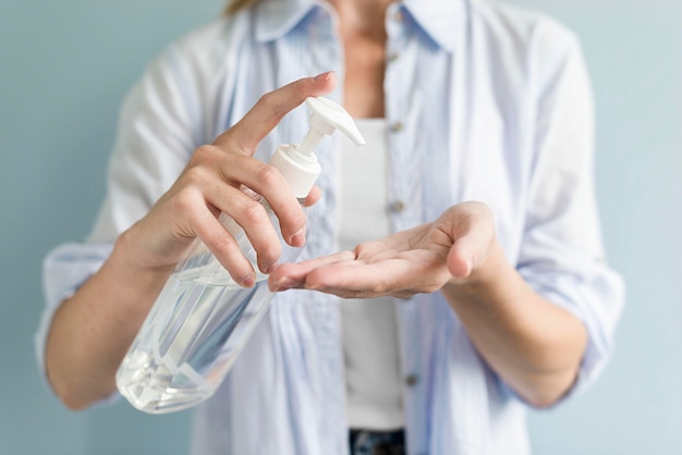 Foto donna che usando disinfettante per le mani