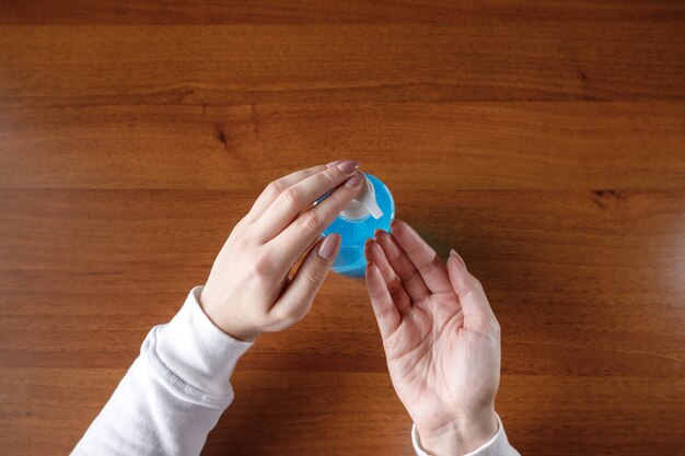 Woman using a hand sanitizer