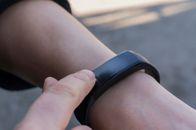 woman using her finger to adjust the smartwatch