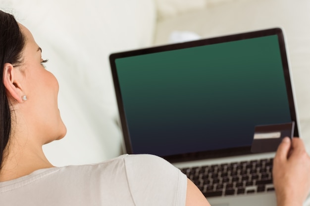 Woman using her laptop on couch