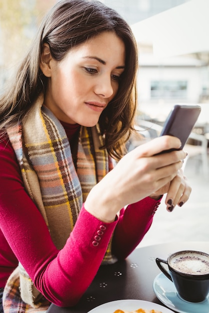 女性が彼女のスマートフォンを使用して