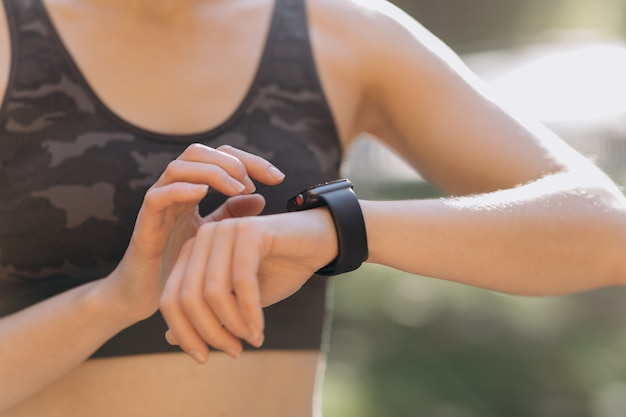 Woman using her smartwatch touchscreen wearable technology device