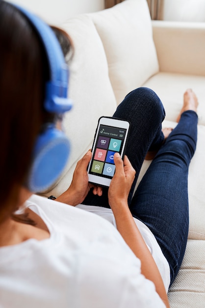 Woman using home control application