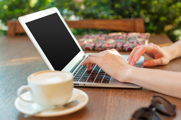 Woman using a laptop during a coffee break