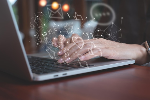 Woman using laptop computer in coffee shop with social media network connection icons