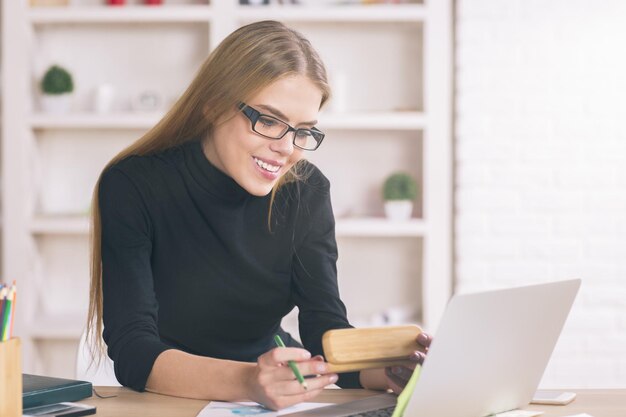 Woman using laptop at desk