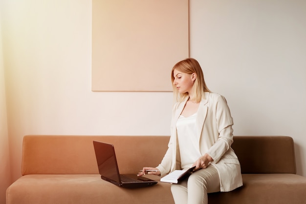 Woman using a laptop in her living room