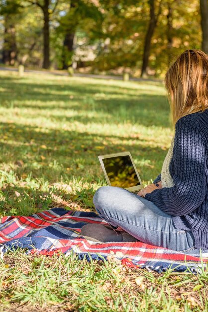 Woman using laptop at park