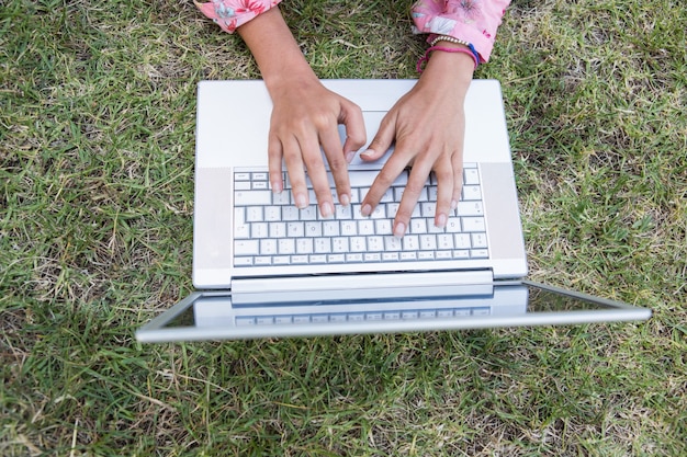 woman using laptop in park