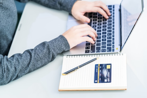 Woman using laptop payment credit card and for online shopping