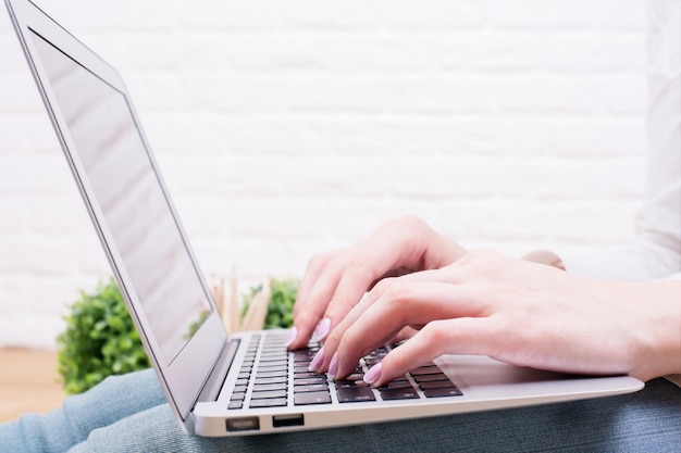 Woman using laptop side