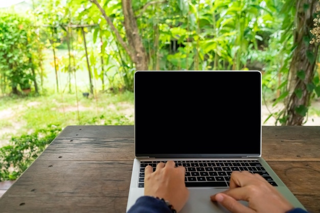 Woman using laptop to work study in vacation day at resort room.