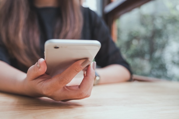 Woman using and looking at smartphone