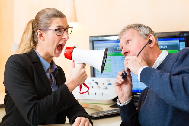 Woman using a loudhailer in hearing test