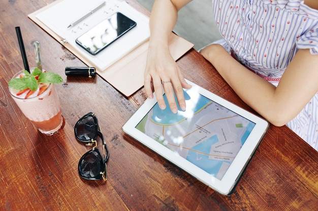 Woman using map on tablet