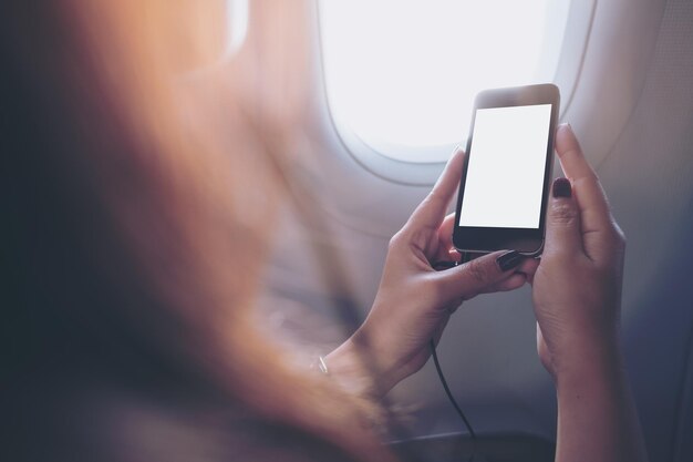 Photo woman using mobile phone in airplane