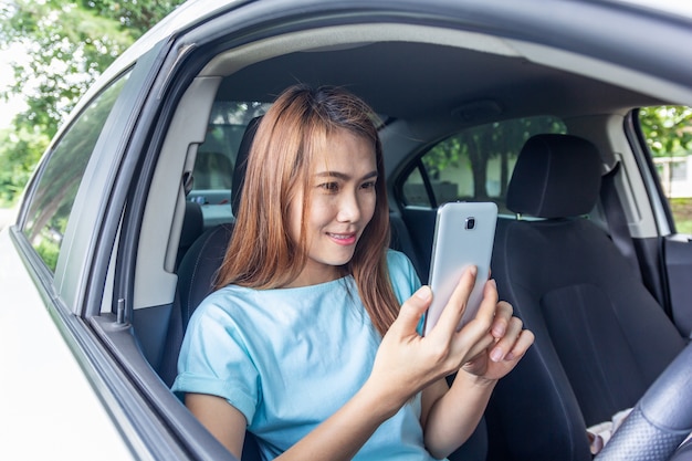 Woman using mobile phone in the car