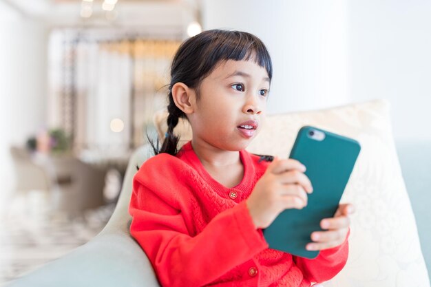 Woman using mobile phone at home