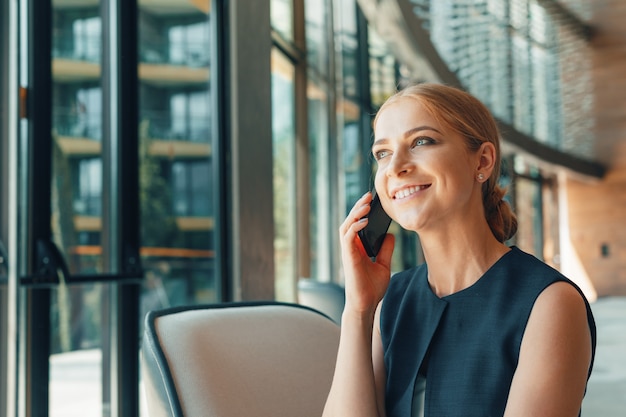 Woman using mobile phone in the office