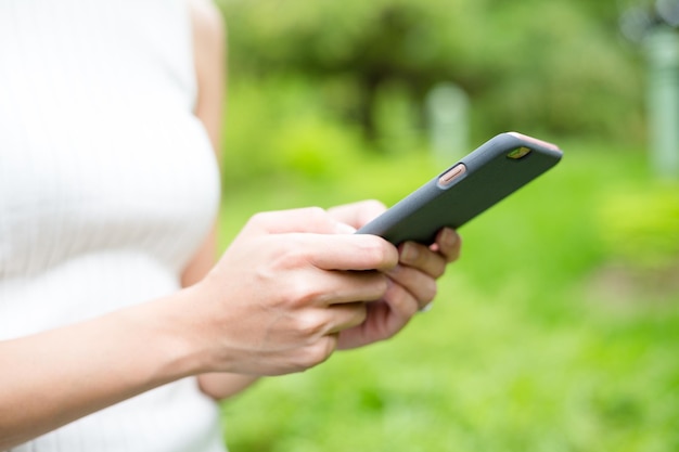 Woman using mobile phone at park