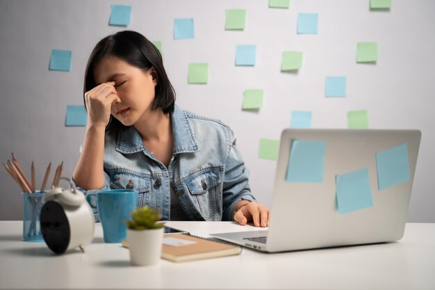 Woman using mobile phone while sitting on table