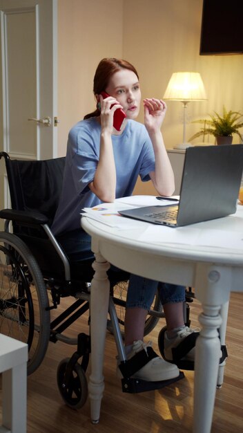 Woman using mobile phone while sitting on table