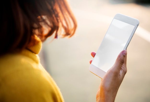 Woman using mobile phone with blank screen