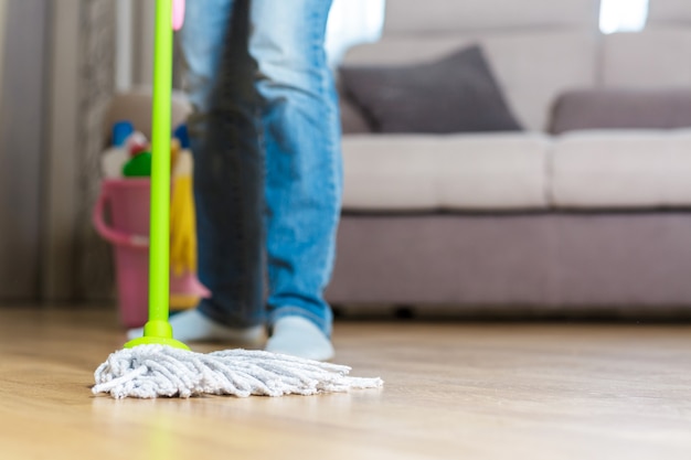 Woman using mop to clean the floor